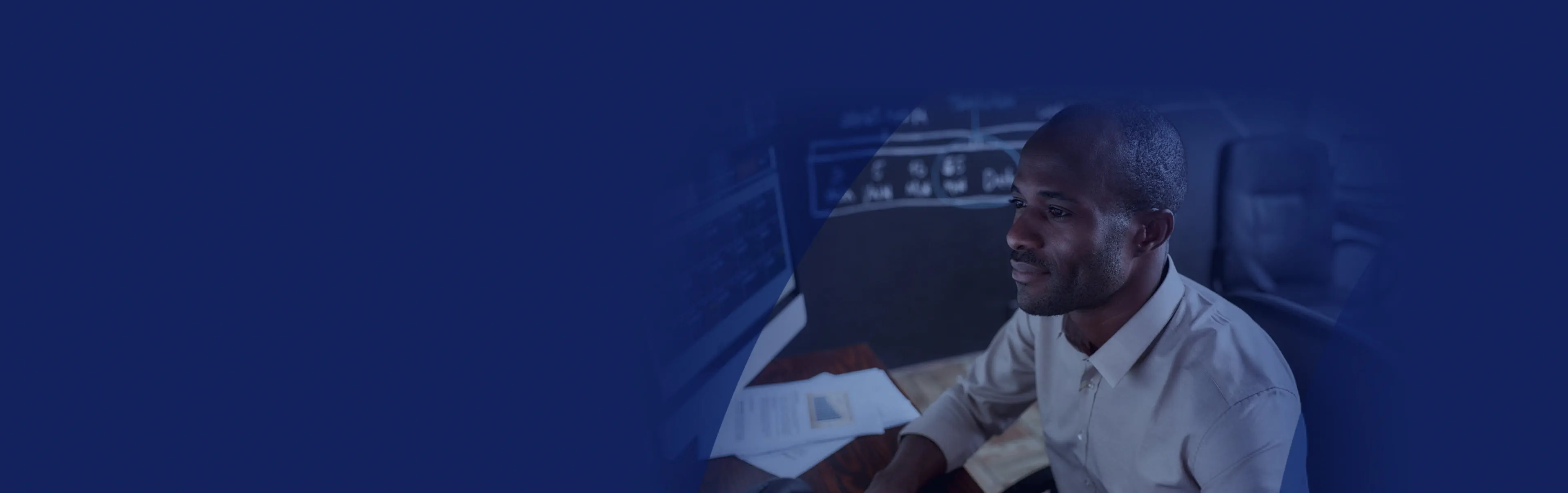 Man looking at financial data on monitor